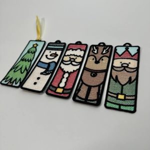 a set of four Christmas bookmarks hanging from a string.